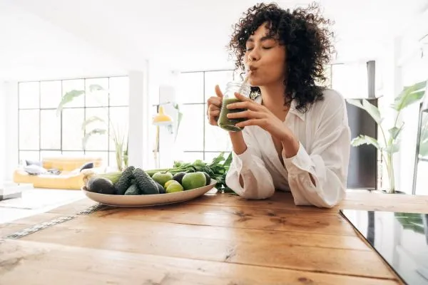 Image of a woman drinking a smoothie