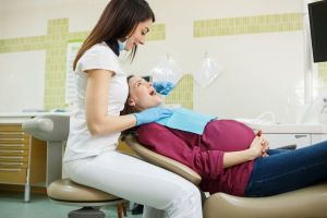 Image of a pregnant woman receiving dental care
