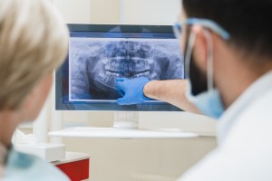 oral surgeon reading an xray